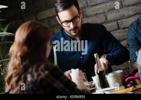 Attractive man and cute woman having meal Stock Photo