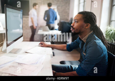 Picture of young attarctive designer working on computer Stock Photo