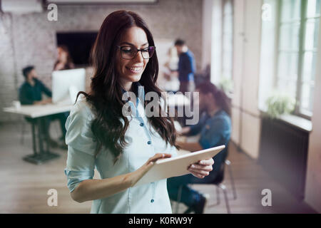 Portrait of young beautiful female designer using tablet Stock Photo