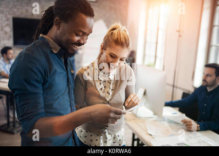 Picture of young designers discussing in office Stock Photo
