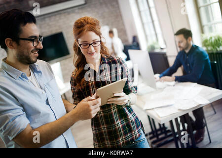 Picture of two young designers looking at tablet Stock Photo