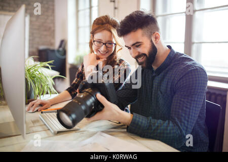 Picture of young attractive designers looking at camera Stock Photo