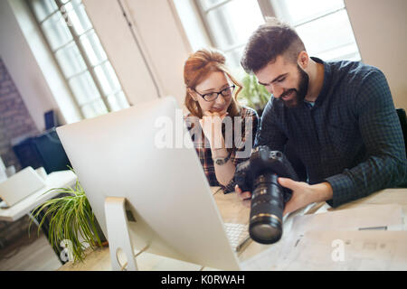 Picture of young attractive designers looking at camera Stock Photo