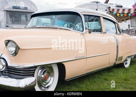1954 American cadillac car and airstream caravan at a vintage retro festival. UK Stock Photo
