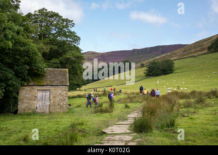 Group of hill walkers on the popular route to Grindsbrook Clough near Edale in the Peak District national park, Derbyshire, England. Stock Photo