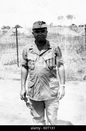 African-American United States Army Lieutenant AL Walker standing in front of barbed wire at Phuoc Vinh Base Camp, with the 1st Cavalry Division, during the Vietnam War, 1964. Stock Photo