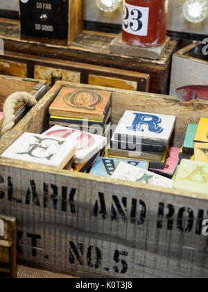 Coloured alphabet letters on wooden boards in a white wooden box. Stock Photo