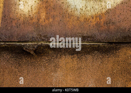 Two parts of Rusted metal plates texture with peeling metal along the joint close up Stock Photo
