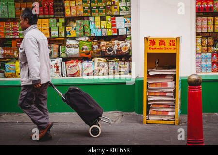 A man with a trolley in Chinatown. London, 2017. Landscape format. Stock Photo