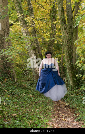 Pretty girl in a forest wearing a long dress Stock Photo - Alamy