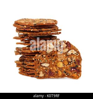 Autumn themed baked crisps with cranberries, nuts and seeds stacked on a white background Stock Photo