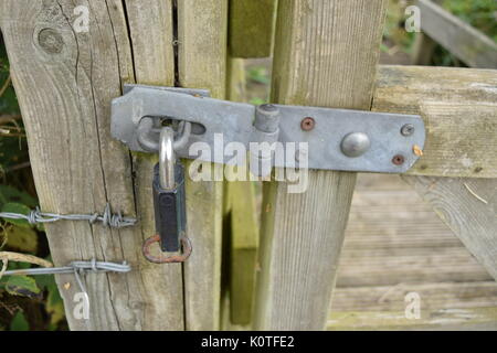 Padlock on a wooden gate Stock Photo