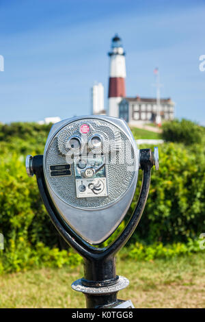 Montauk point lighthouse and vintage binocular in front (focus on Binocular), Long Island Stock Photo