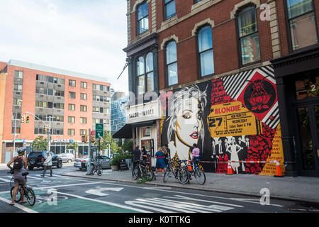 New York, USA. 23rd Aug, 2017. Passersby stop to admire a newly completed mural, by Shepard Fairey, in the East Villagehe mural features Debbie Harry, lead singer for the rock group Blondie, who got their start in 1979 at CBGB which was located across the street. Fairy's work is also featured in Blondie's latest album “Polinator” which was released in May 2017. Credit: Stacy Walsh Rosenstock/Alamy Live News Stock Photo