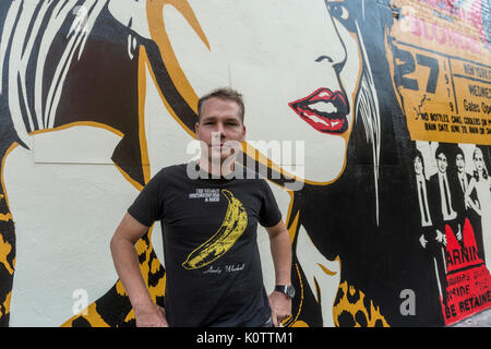 New York, USA. 23rd Aug, 2017. Shepard Fairey, and his newly completed mural. The mural features Debbie Harry, lead singer for the rock group Blondie, who got their start in 1979 at CBGB which was located across the street. Fairy's work is also featured in Blondie's latest album “Polinator” which was released in May 2017. Credit: Stacy Walsh Rosenstock/Alamy Live News Stock Photo