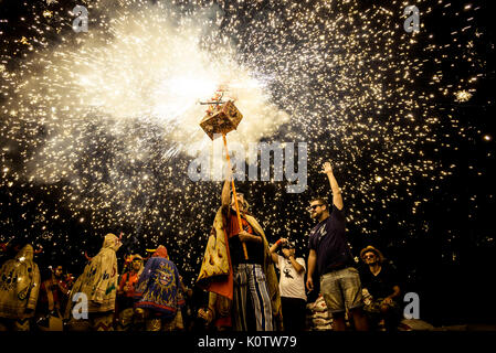 Barcelona, Spain. 24th Aug, 2017. Members of 'Diables de Sitges - colla jove' set off their fireworks among the crowd of spectators at the 'Festa Major de Sitges'. Credit: Matthias Oesterle/Alamy Live News Stock Photo