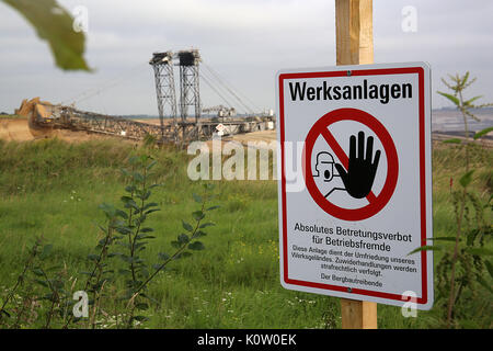 A warning sign giving notice of the premises of RWE's mine photographed on the edges of the Garzweiler surface mine near Erkelenz, Germany, 24 August 2017. No protests have been reported yet at the start of the registered protest day by brown coal opposers. Photo: Oliver Berg/dpa Stock Photo