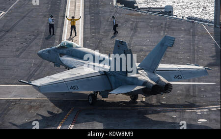 170821-N-NQ487-082  ATLANTIC OCEAN (Aug. 21, 2017) Aviation Boatswain's Mate (Handling) 3rd Class Ryan Borba, middle, directs an F/A-18E Super Hornet assigned to the “Sunliners” of Strike Fighter Squadron (VFA) 81 after landing on the flight deck of the aircraft carrier USS Harry S. Truman (CVN 75). Harry S. Truman is underway conducting flight deck certifications in preparation for future operations. (U.S. Navy photo by Mass Communication Specialist Seaman Kaysee Lohmann/Released) Stock Photo