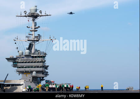 170821-N-PE636-540 ATLANTIC OCEAN (Aug. 21, 2017) An F/A-18 Super Hornet, assigned to Carrier Air Wing 1, flies over the flight deck of USS Harry S. Truman (CVN 75). Truman is currently underway conducting Flight Deck Certifications in preparation for future operations. (U.S. Navy photo by Mass Communication Specialist 2nd Class Anthony Flynn/Released) Stock Photo