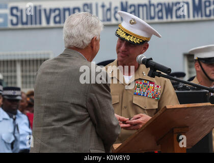 Graeme Day gives U.S. Marine Corps Maj. Gen. Eric M. Smith, commanding general of 1st Marine Division, a bible that dates back to World War II in Honiara, Guadalcanal, Solomon Islands, Aug. 7, 2017. The bilbe was given to Day's family by a U.S. Marine during World War II. (U.S. Coast Guard photo by Petty Officer 2nd Class Tara Molle) Stock Photo