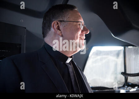 The Bishop of Biloxi, Bishop Louis Kihneman, looks around the flight deck of a WC-130J Super Hercules aircraft Aug. 17, 2017 at Keesler Air Force Base, Mississippi. Kihneman visited the 403rd Wing to learn more about its mission and during his visit took a moment to bless the wing's fleet of aircraft.  (U.S. Air Force photo/Staff Sgt. Heather Heiney) Stock Photo