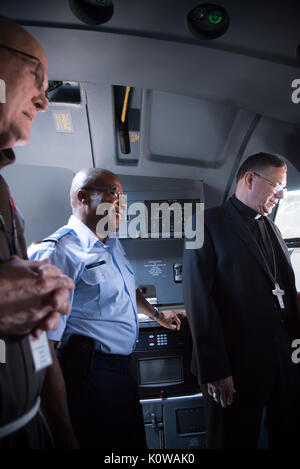 Chaplain (Maj.) Laserian Nwoga, 81st Training Wing, and the Bishop of Biloxi, Bishop Louis Kihneman, look inside the flight deck of a WC-130J Super Hercules aircraft Aug. 17, 2017 at Keesler Air Force Base, Miss. Kihneman visited the 403rd Wing to learn more about its mission and during his visit took a moment to bless the wing's fleet of aircraft.  (U.S. Air Force photo/Staff Sgt. Heather Heiney) Stock Photo