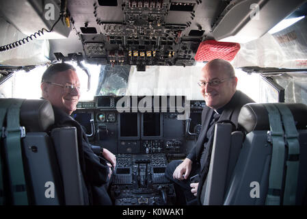 The Bishop of Biloxi, Bishop Louis Kihneman, and Monsignor Dominick Fullam pose for a photo in the flight deck of a WC-130J Super Hercules aircraft Aug. 17, 2017 at Keesler Air Force Base, Mississippi. Kihneman visited the 403rd Wing to learn more about its mission and during his visit took a moment to bless the wing's fleet of aircraft.  (U.S. Air Force photo/Staff Sgt. Heather Heiney) Stock Photo