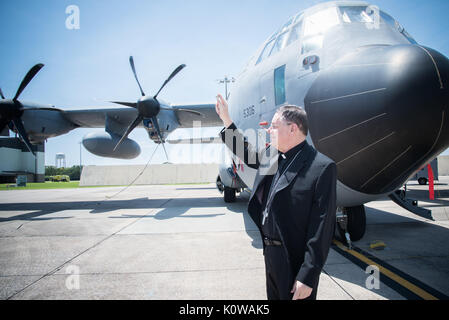 The Bishop of Biloxi, Bishop Louis Kihneman, blesses the 403rd Wing's fleet of aircraft Aug. 17, 2017 at Keesler Air Force Base, Mississippi. Kihneman visited the 403rd Wing to learn more about its mission. (U.S. Air Force photo/Staff Sgt. Heather Heiney) Stock Photo