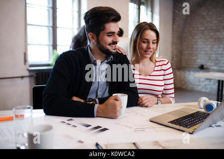 Two young perspective architects working on laptop Stock Photo