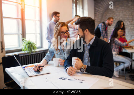 Two young perspective architects working on laptop Stock Photo