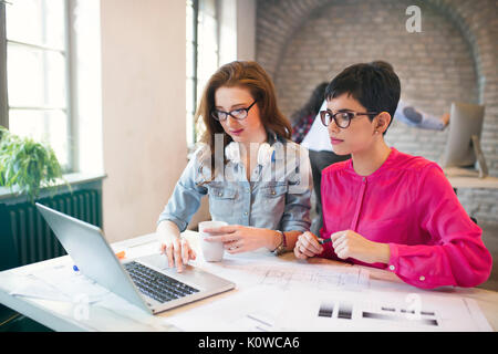 Two young perspective architects working on laptop Stock Photo