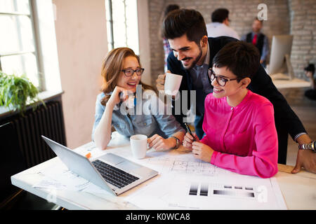 Group of young architects working on laptop Stock Photo