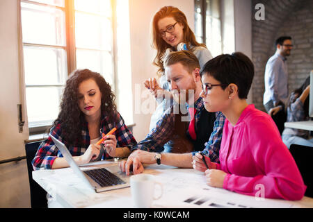 Group of young architects working on laptop Stock Photo