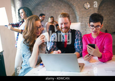 Group of young architects working on laptop Stock Photo