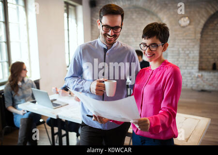 Portrait of two architects looking at project scheme Stock Photo
