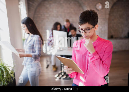 Young attractive female architect using digital tablet Stock Photo