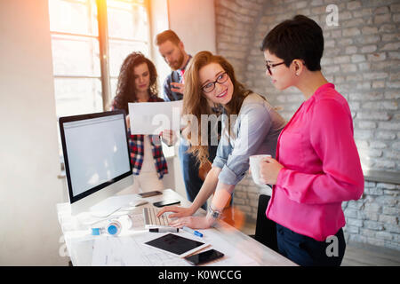 Group of young architects working on computer Stock Photo