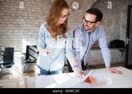 Portrait of two architects looking at project scheme Stock Photo