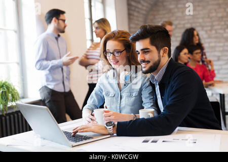 Two young architects working on laptop in office Stock Photo