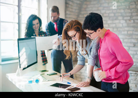 Group of young architects using digital tablet Stock Photo