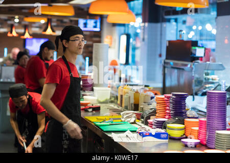 Busy production of sushi in Japanese restaurant Stock Photo