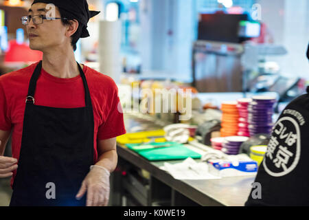 Busy production of sushi in Japanese restaurant Stock Photo