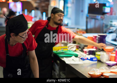 Busy production of sushi in Japanese restaurant Stock Photo