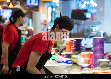 Busy production of sushi in Japanese restaurant Stock Photo