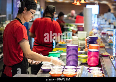 Busy production of sushi in Japanese restaurant Stock Photo