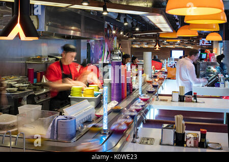 Busy production of sushi in Japanese restaurant Stock Photo