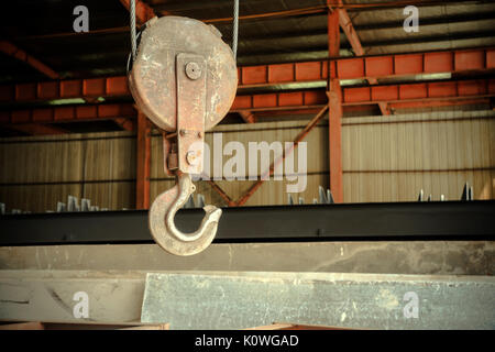 Inside the factory overhead crane hook Closeup Stock Photo