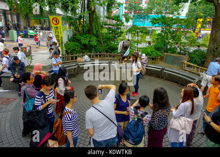 TOKYO, JAPAN JUNE 28 - 2017: Unidentified people visit Hachiko dog statue in Shibuya, Tokyo. Hachiko was a famous dog who waited for owner after his death Stock Photo