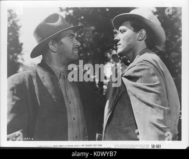 A movie still scene from 'The Tougher They Come' (1950 Columbia Pictures film), showing a man holding threateningly another man by the collar as they glared at each other, 1950. Stock Photo