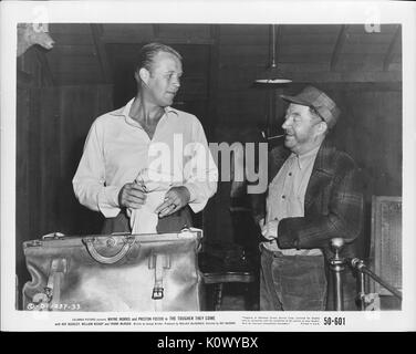 A movie still scene from 'The Tougher They Come' (1950 Columbia Pictures film), showing two people talking seriously, 1950. Stock Photo